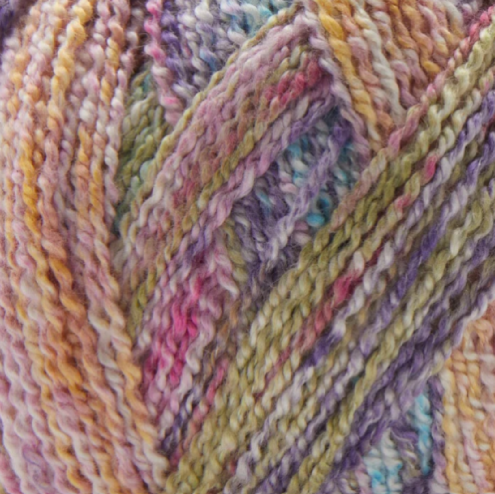 Close-up image of multi-colored yarn alongside a knit up swatch in the colors pink green blue purple 