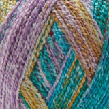 Close-up image of multi-colored yarn alongside a knit up swatch in the colors purple orange teal green red