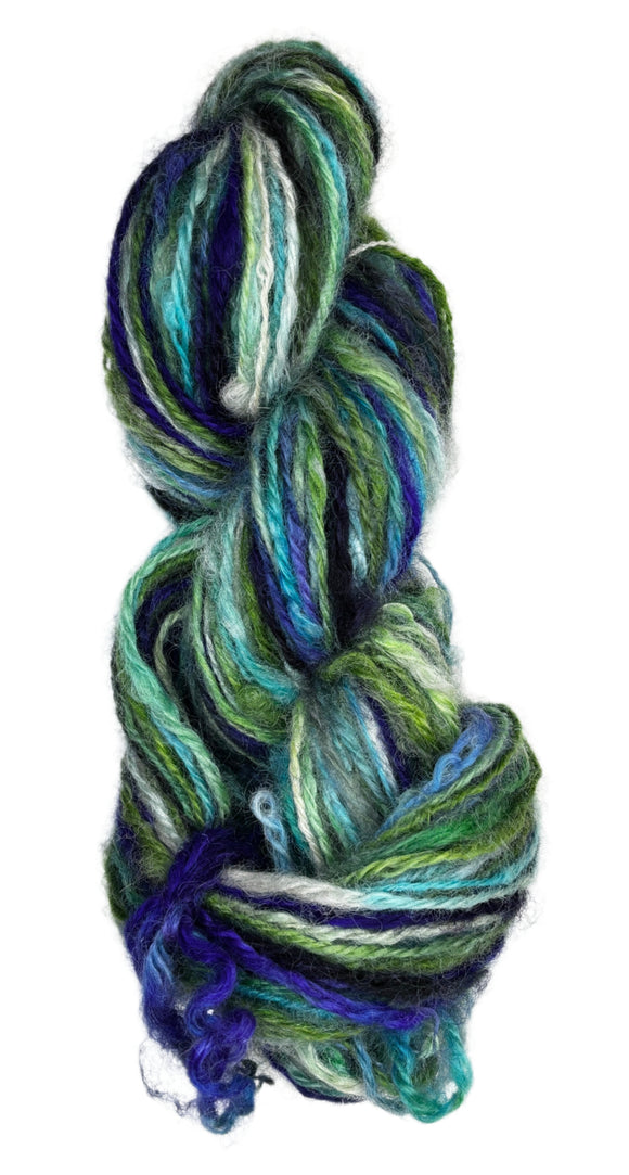 Handspun skein of handdyed yarn from Tronstad Ranch in Wyoming in the colors white blue green 