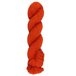 Orange skein of mountain meadow wool yarn on a white background