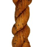 Skein of hand-dyed BFL Tweed wool yarn in the color orange