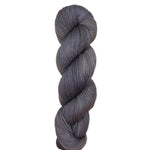 Gray skein of yarn on a light wooden surface