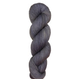 Gray skein of yarn on a light wooden surface