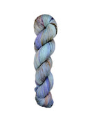 A skein of hand-dyed fingering/sock yarn color grey periwinkle brown peach brown speckles