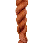 A skein of hand-dyed fingering/sock yarn color rust orange