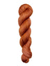 A skein of hand-dyed fingering/sock yarn color rust orange