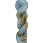 A skein of hand-dyed fingering/sock yarn color blue tan orange brown speckles