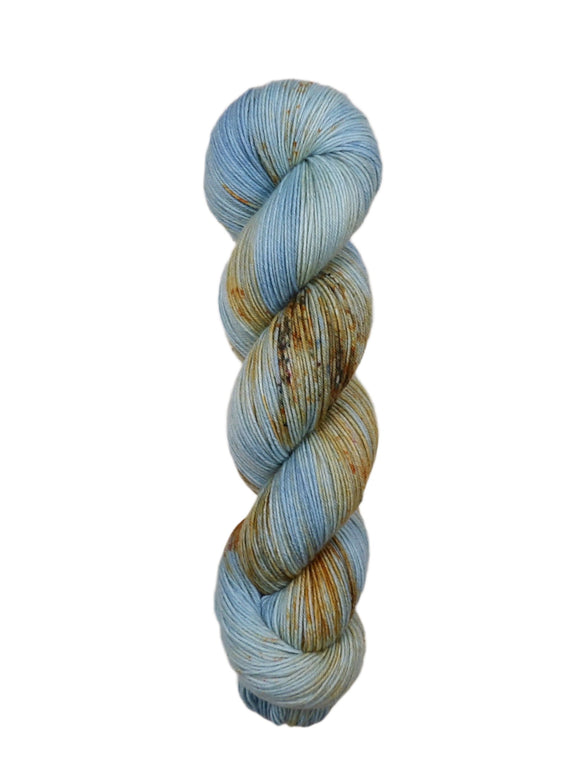 A skein of hand-dyed fingering/sock yarn color blue tan orange brown speckles