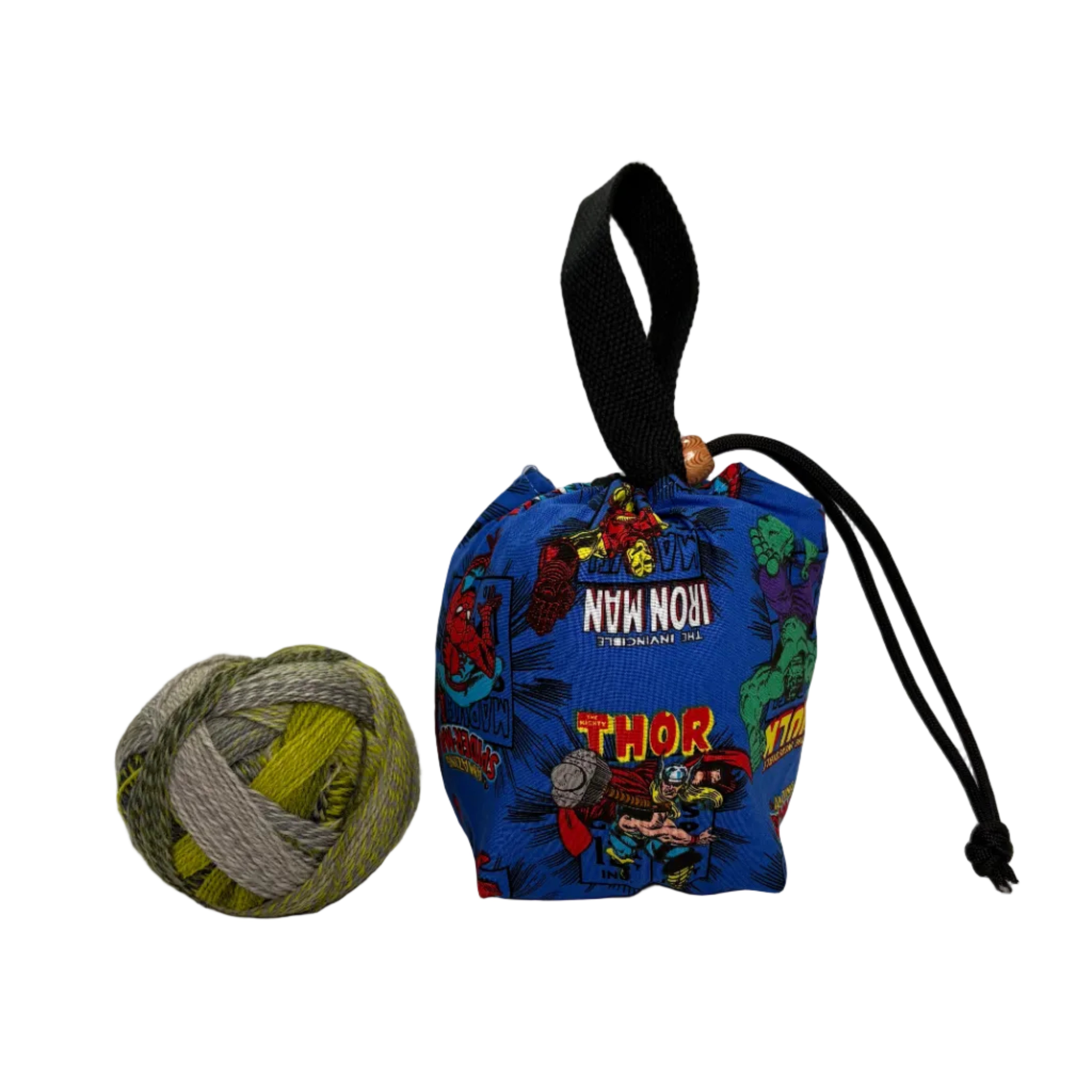 Blue drawstring bag with superhero designs on a white surface, next to a ball of yarn.