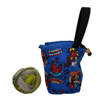 Blue bag with colorful superhero patterns on a white surface