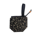 Black floral-patterned pouch with a strap on a white background