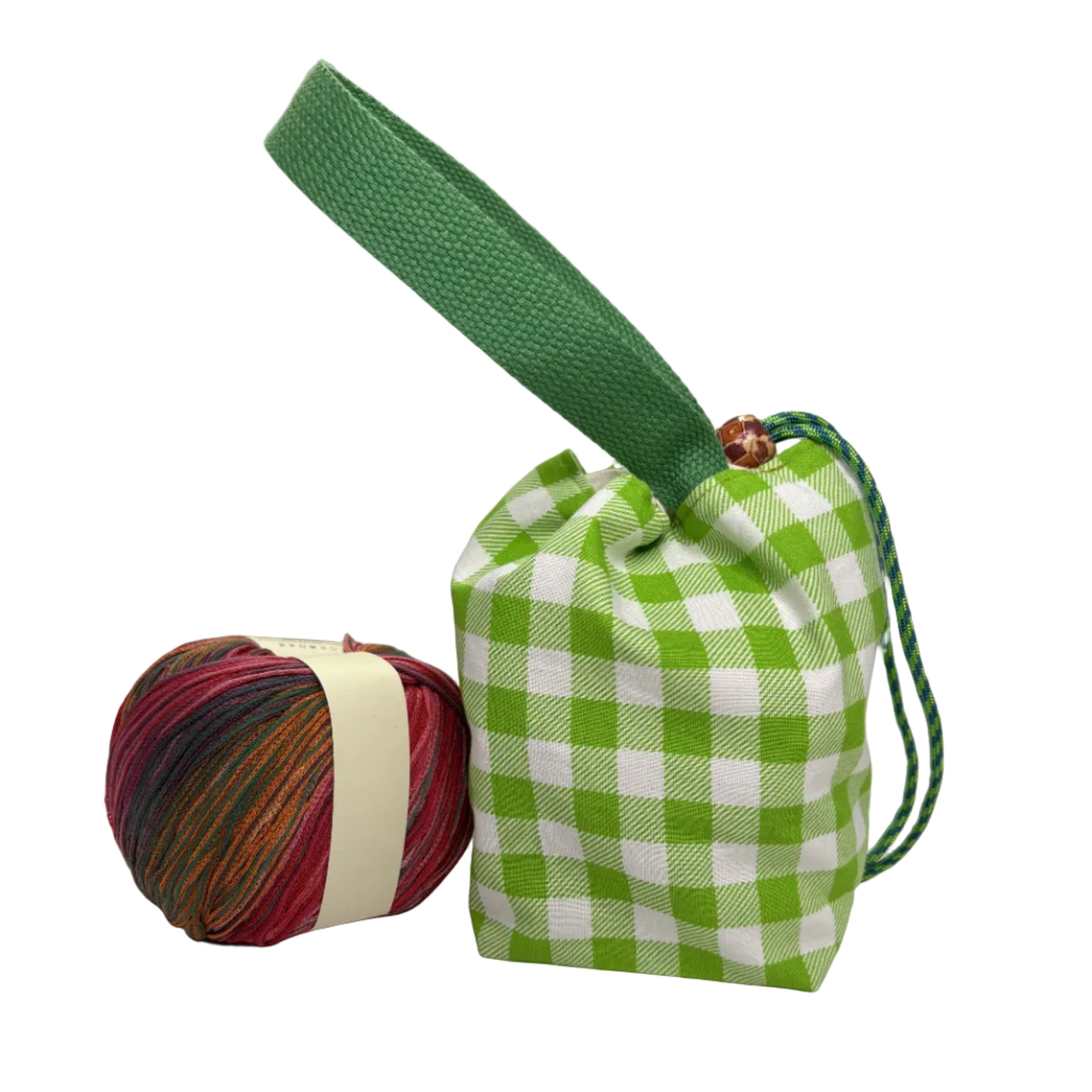 A green and white gingham drawstring pouch with a wide green handle, displayed next to a ball of variegated yarn 