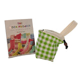 Green checkered drawstring pouch with a book titled 'The Sock Project' on a white surface.