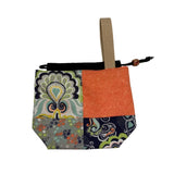 Patchwork fabric pouch with a strap on a white background