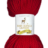 Red skein of yarn with a label on a white background