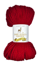 Red skein of yarn with a label on a white background