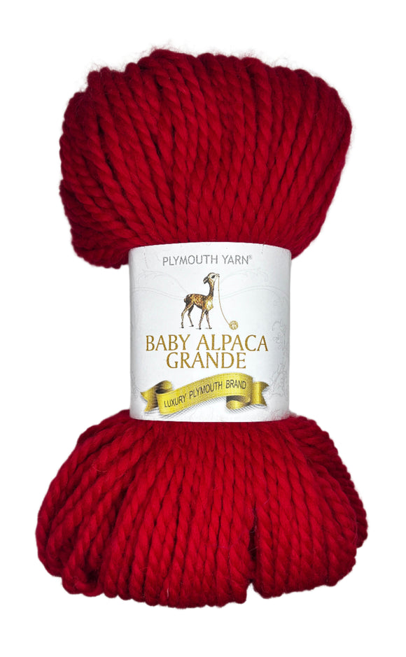 Red skein of yarn with a label on a white background