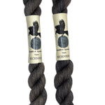 Mini skeins of hand dyed fingering weight yarn in the color dark grey