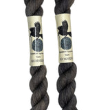 Mini skeins of hand dyed fingering weight yarn in the color dark grey