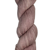Skein of hand dyed fingering weight yarn in the color dusty rose