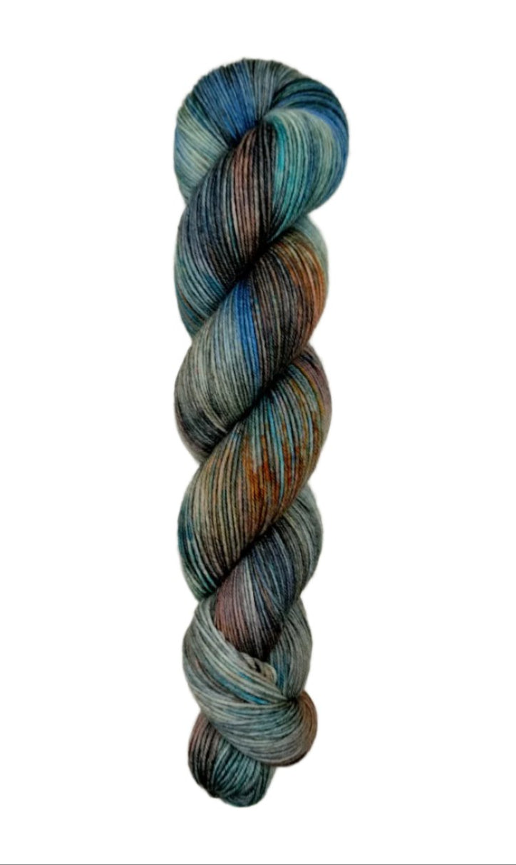 A skein of hand-dyed fingering/sock yarn color grey blue orange brown red black speckles