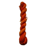 Braided orange yarn on a white background