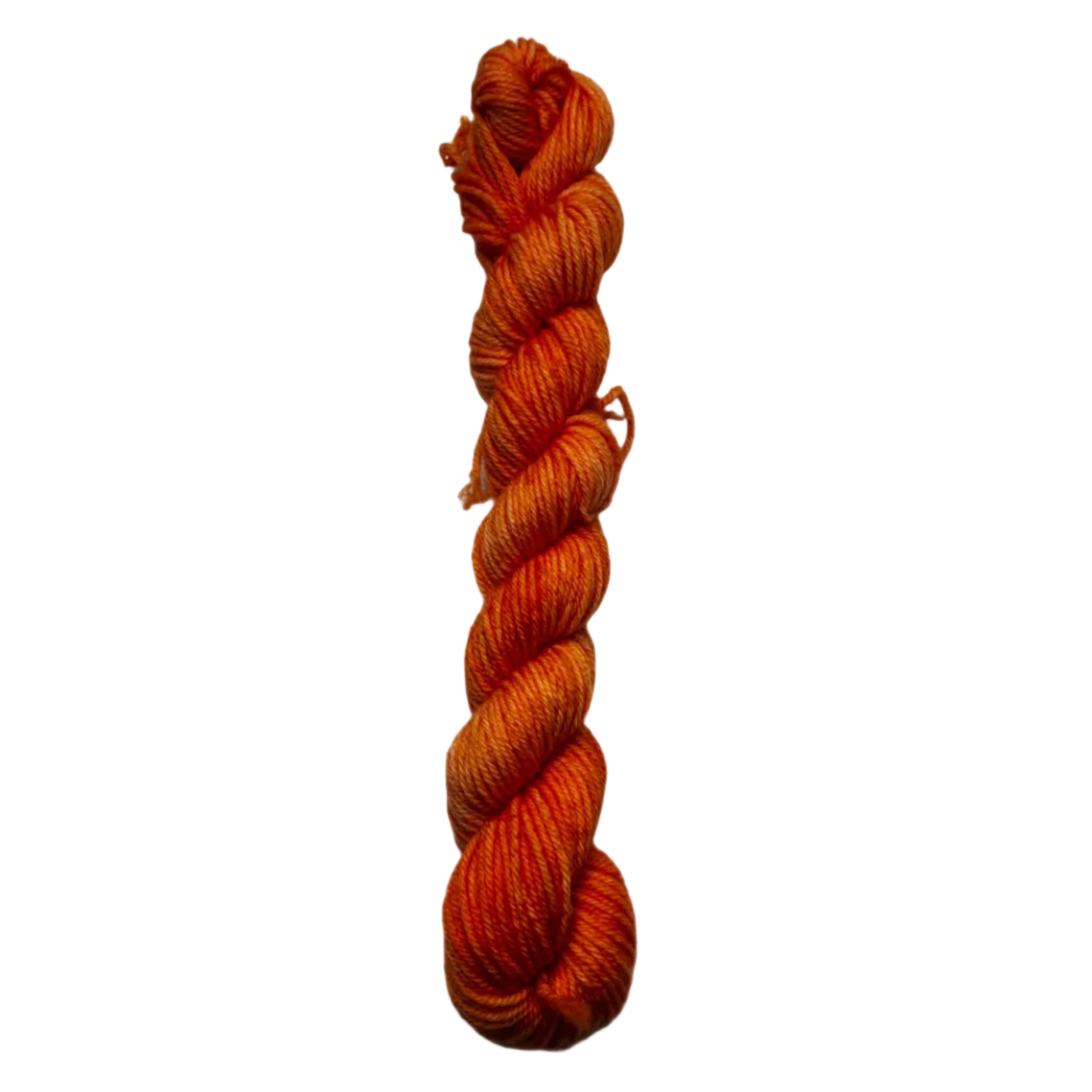 Braided orange yarn on a white background