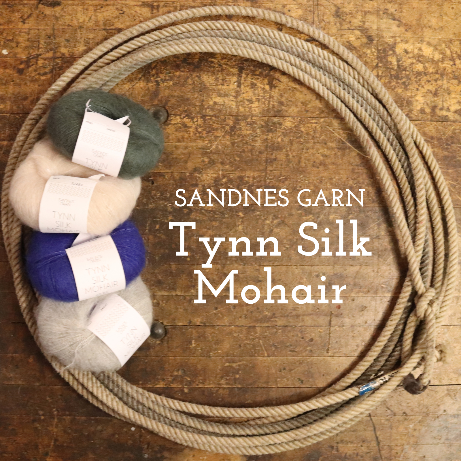A coiled beige rope or cord arranged in a circle on a rustic wooden surface, with four skeins of yarn stacked along the left side. White text reads 'SANDNES GARN Tynn Silk Mohair.