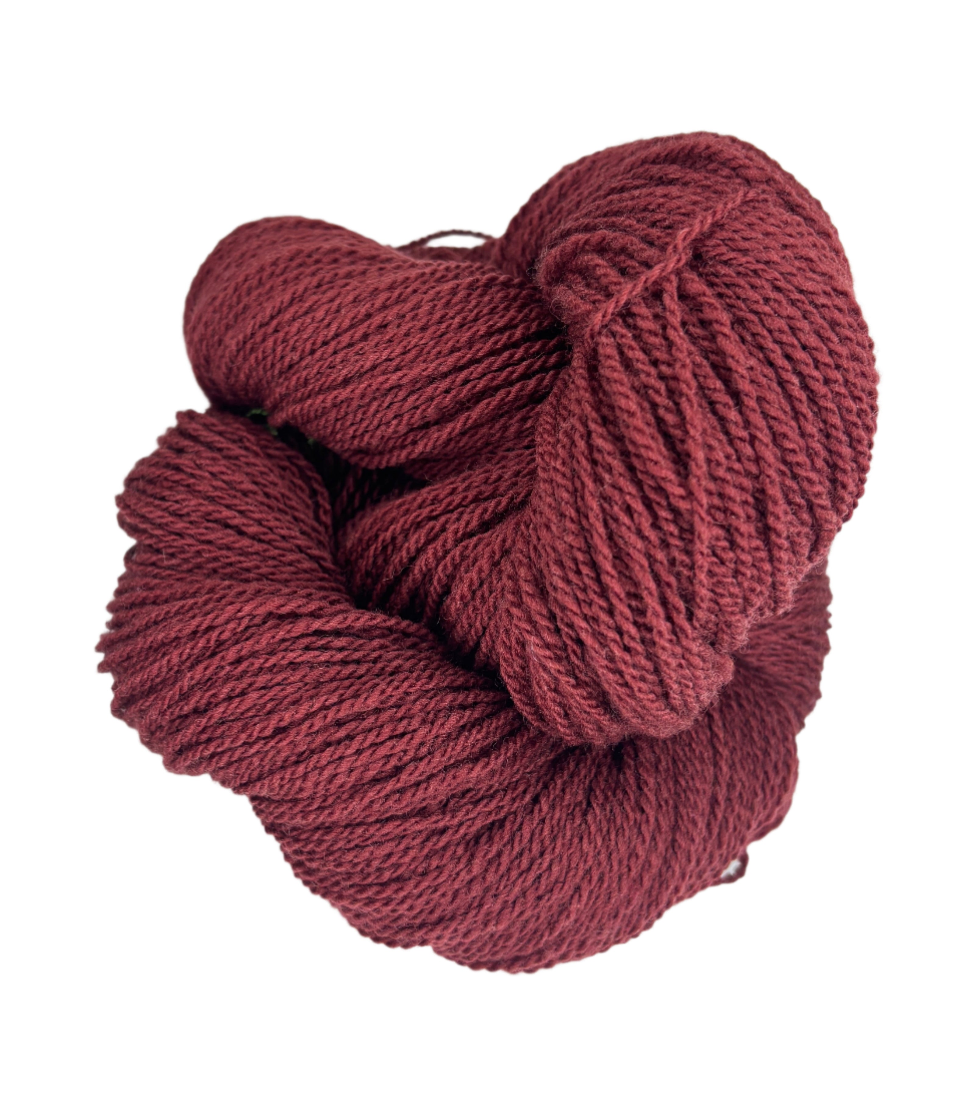 A ball of Mountain Meadow Wool Yarn in the color deep rust red