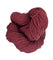 A ball of Mountain Meadow Wool Yarn in the color deep rust red