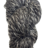 Skein of handspun yarn in the colors black and grey