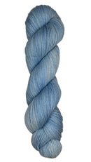 Skein of hand dyed fingering weight yarn in the color sky blue