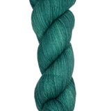 Skein of hand dyed fingering weight yarn in the color spruce green