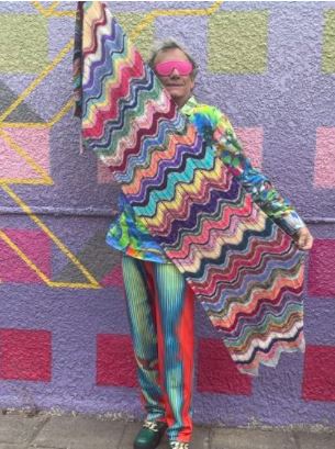 StevenBe holding a colorful textured wrap