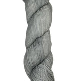 Skein of hand dyed fingering weight yarn in the color grey