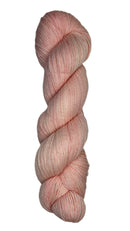 Skein of hand dyed fingering weight yarn in the color light pink