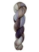 A skein of hand-dyed fingering/sock yarn color white grey tan blue brown