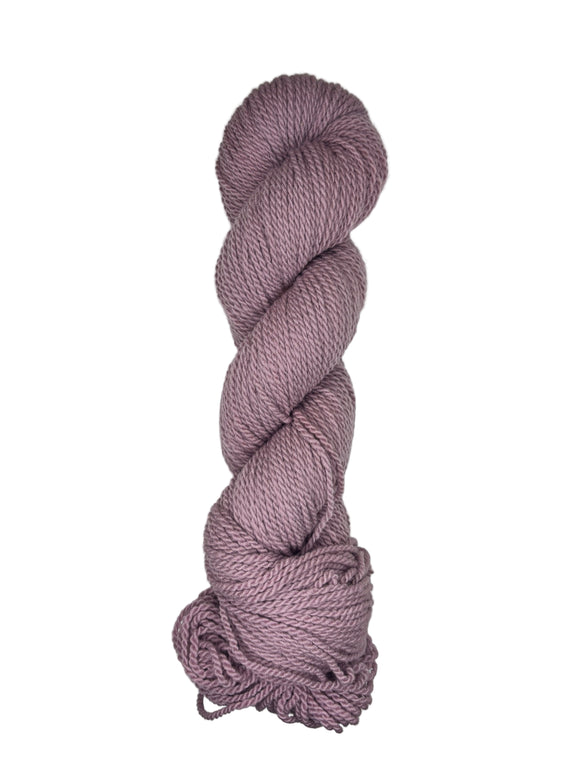 Light purple skein of mountain meadow wool yarn on a white background