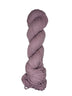 Light purple skein of mountain meadow wool yarn on a white background