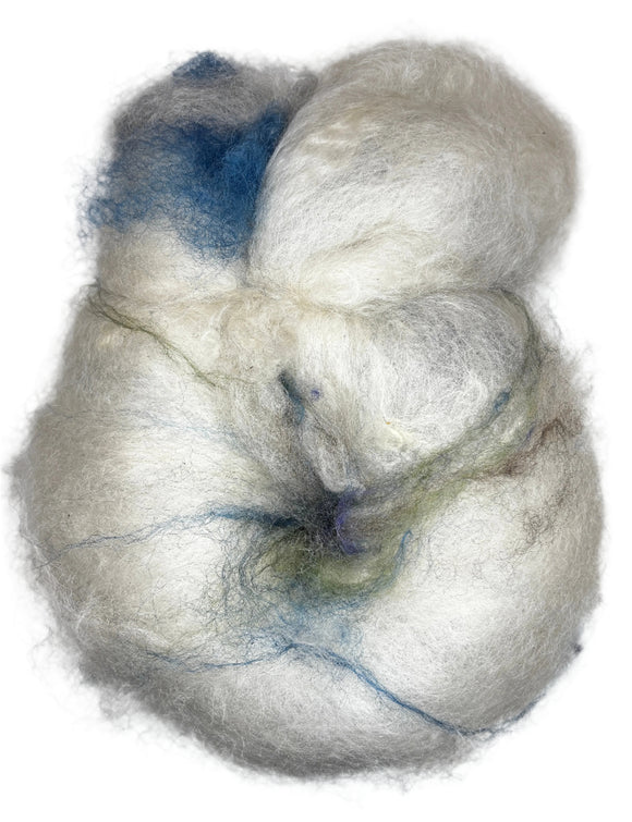 A hand-dyed wool rolag in the colors natural white blue green brown