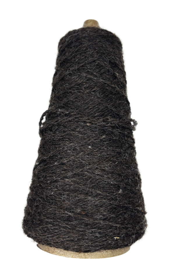 A cone of handspun worsted weight wool in the color natural brown
