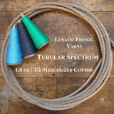 Photo of three colorful cones of Tubular Spectrum Lunatic Fringe Yarns