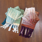 Two Clasped Warp and Weft woven scarves with squared geometric patterns