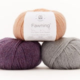 Balls of Universal Yarn Fawning DK weight yarn in the colors purple grey and peach