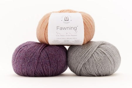 Balls of Universal Yarn Fawning DK weight yarn in the colors purple grey and peach