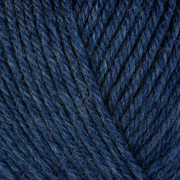 Detailed view of a skein of superwash wool yarn, showcasing a navy blue hue.