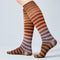 Colorful striped knee-high socks on a light gray background