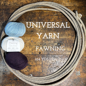 Balls of Universal Yarn Fawning DK weight yarn on a wooden surface