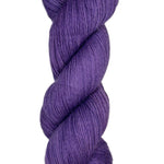 Skein of hand dyed fingering weight yarn in the color violet