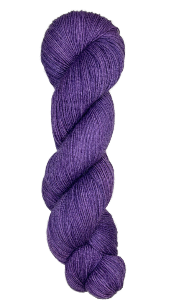 Skein of hand dyed fingering weight yarn in the color violet